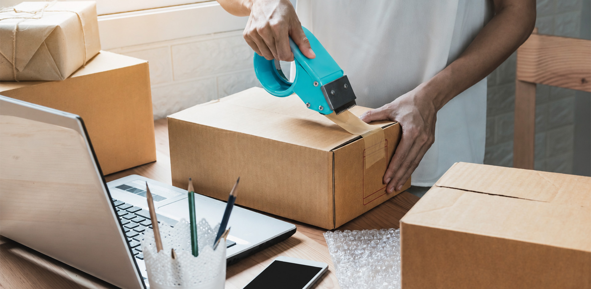 Packing tape and shipping boxes prepared for small business orders